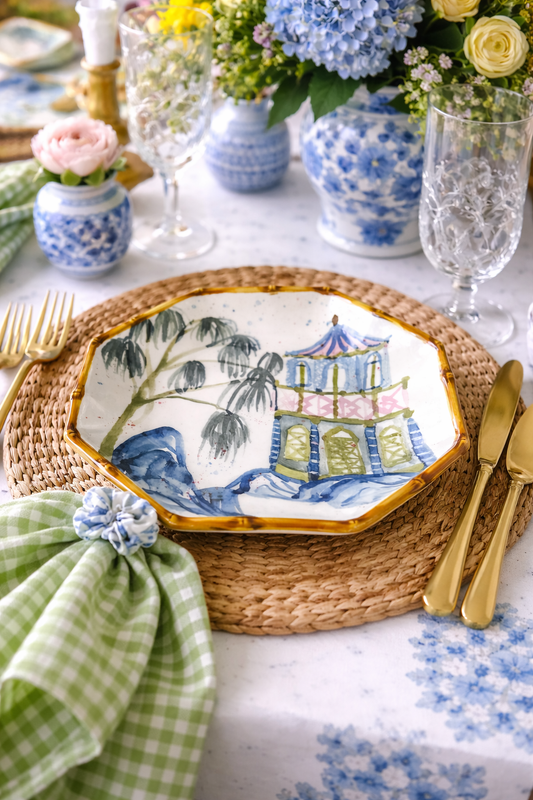 Hand painted octagon shaped plate with house, palm trees and bamboo style edge